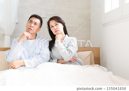 A couple waking up and having a conversation in bed A couple waking up and having a conversation in bed 135041830