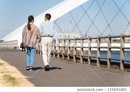 A middle-aged couple walking along a promenade 135041865