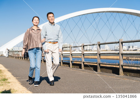 A middle-aged couple walking along a promenade 135041866