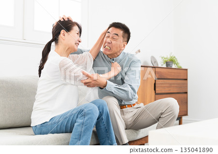Mature couple sitting on sofa 135041890
