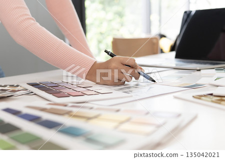 Creative web designer planning UI application and developing digital template 135042021