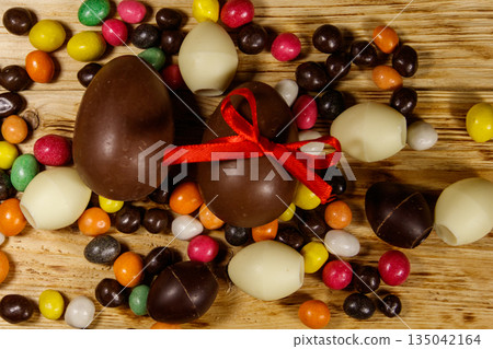 Easter composition with chocolate eggs on wooden background 135042164