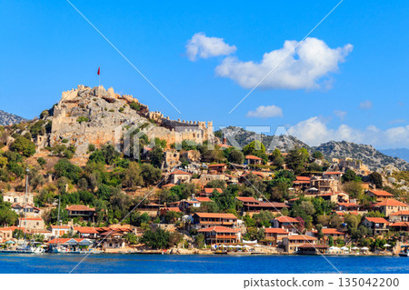 View of ancient Lycian town Simena with fortress on a mount on the coast of the Mediterranean sea in Antalya Province, Turkey 135042200