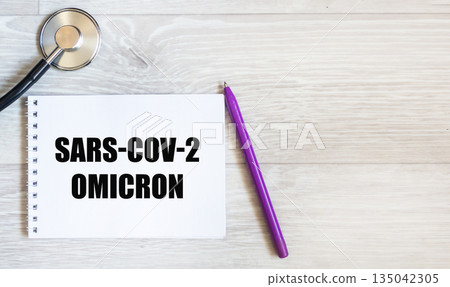 Omicron SARS-CoV-2 .There is an Omicron SARS-CoV-2 entry on a white background on the notebook. Omicron SARS-CoV-2 .There is an Omicron SARS-CoV-2 entry on a white background on the notebook. 135042305