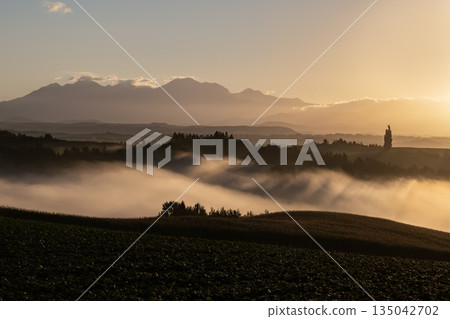 Morning mist on the ground and hills 135042702