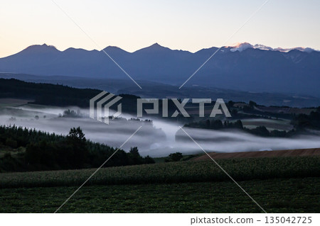 Morning mist on the ground and hills Morning mist on the ground and hills 135042725