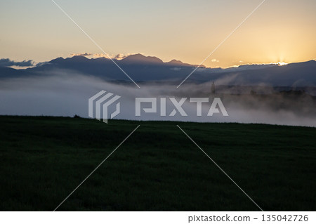 Morning mist on the ground and hills Morning mist on the ground and hills 135042726