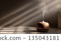 A minimalist aroma diffuser releasing soft steam in warm natural light 135043181