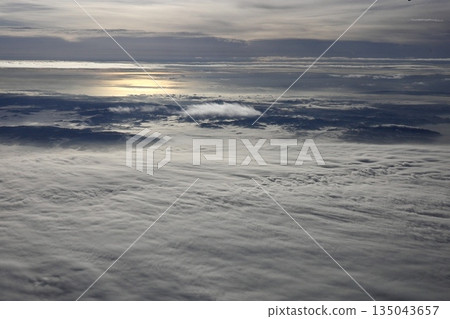 A white sea of clouds that spreads out like the ocean seen from inside the plane 135043657