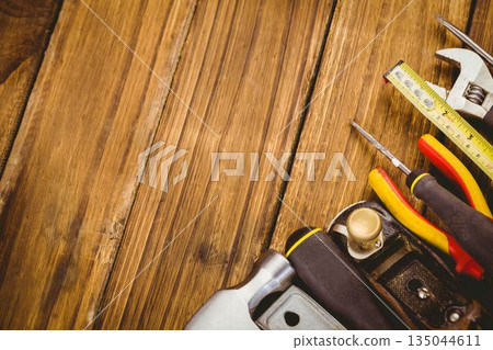 Vector flat lay is showing wrench tape and screwdrivers on wood grain copy space Vector flat lay is showing wrench tape and screwdrivers on wood grain copy space 135044611