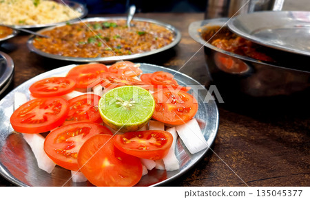 Traditional Indian Dhaba Meal with Rice, Curry, and Salad 135045377