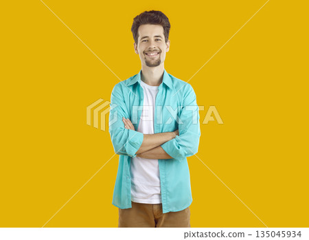 Portrait of smiling young man with neatly shaved beard and mustache confidently watching straight. Portrait of smiling young man with neatly shaved beard and mustache confidently watching straight. 135045934