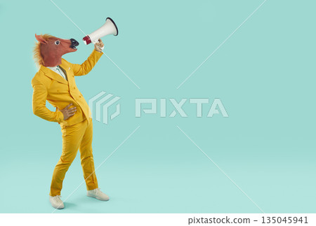 Funny businessman with horse head shouting through megaphone Funny businessman with horse head shouting through megaphone 135045941
