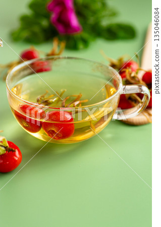 Light hot rosehip tea with flowers and berries Light hot rosehip tea with flowers and berries 135046084