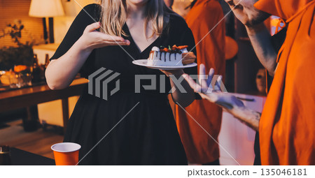 Friends enjoying a Halloween party at a bar making a toast 135046181