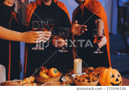Friends enjoying a Halloween party at a bar making a toast Friends enjoying a Halloween party at a bar making a toast 135046186