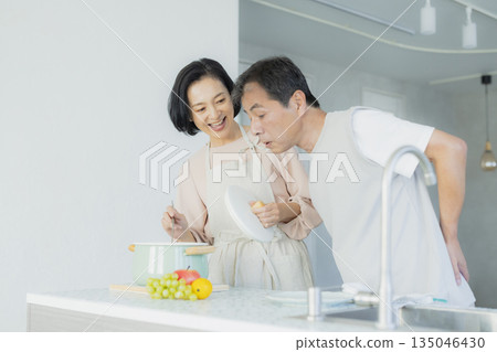 Middle-aged woman doing housework in the kitchen 135046430