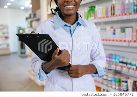 African american young woman in a lab coat at the drug store African american young woman in a lab coat at the drug store 135046771