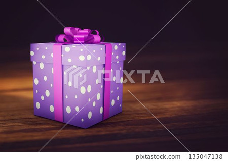 Purple polka dot gift box is sitting on wooden tabletop, showing pink ribbon and warm lighting Purple polka dot gift box is sitting on wooden tabletop, showing pink ribbon and warm lighting 135047138