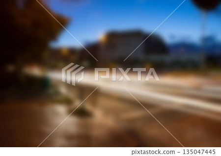 Light trails on road at dusk Light trails on road at dusk 135047445