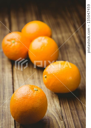 Close-up of oranges on wooden table 135047459