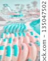 Blurred photo of inflatable water slide rings, summer abstract background or wallpaper. 135047502