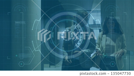 Walking male and female professionals examining holographic data in office corridor, with tablet 135047730