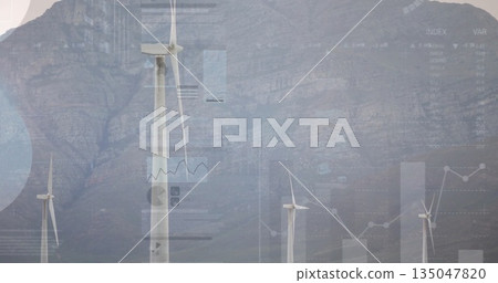 Spinning central wind turbine rotating before rocky cliff at wind farm, with data overlay graphics 135047820