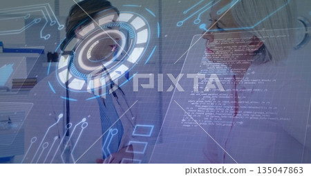 Discussing doctor and patient examining holographic UI display in clinic room, stethoscope, binders 135047863