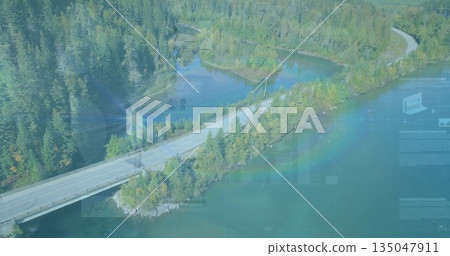 Winding two-lane road running over bridge through lakeside evergreen forest, with clear blue water Winding two-lane road running over bridge through lakeside evergreen forest, with clear blue water 135047911