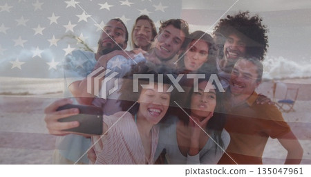 Smiling group of friends taking selfie at sandy beach, with smartphone and American flag overlay Smiling group of friends taking selfie at sandy beach, with smartphone and American flag overlay 135047961