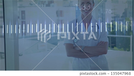 Standing worker in scrubs and monitoring digital waveform in hospital lobby wristwatch, copy space 135047968