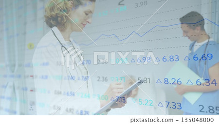 Female doctor with stethoscope reviewing tablet in ward, nurse consulting patient with folder 135048000