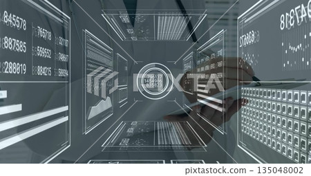 Interacting analyst tapping stylus on tablet at office workstation, translucent holographic panels 135048002