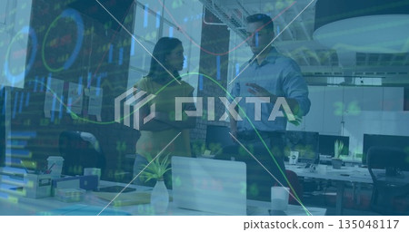 Analyst and project manager discussing and analyzing financial charts in open office with laptop 135048117