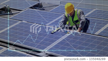 Inspecting helmeted technician leveling panels on rooftop with spirit level, copy space 135048289