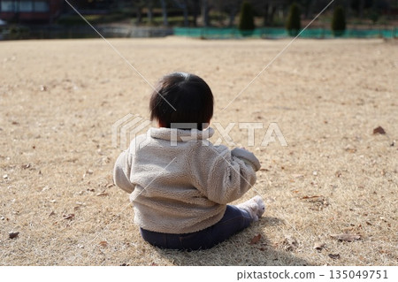 Back view of a baby boy relaxing in nature Back view of a baby boy relaxing in nature 135049751