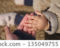 Baby's plump hands and mother's hands 135049755