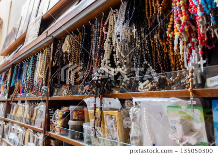 Different Christian crosses made of metal and wood hang for sale in a church store, symbolising faith, spirituality, religion, tradition, and sacred items. Religious symbol Different Christian crosses made of metal and wood hang for sale in a church store, symbolising faith, spirituality, religion, tradition, and sacred items. Religious symbol 135050300