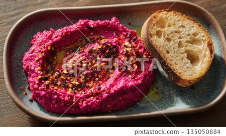 Bright pink dip with bread slice 135050884