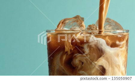 Pouring milk into iced coffee drink Pouring milk into iced coffee drink 135050907