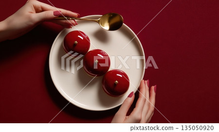 Hands hold dessert on red table Hands hold dessert on red table 135050920