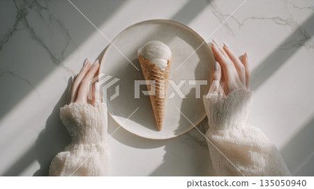 Holding an ice cream cone on a plate 135050940