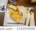 Lasagna served on plates on a table in a restaurant 135050999