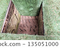 Vietnam War military pit trap with metal spikes hidden under grass cover historical Viet Cong defensive trap and guerrilla warfare concept 135051000
