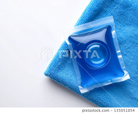 Mockup for branding cleaning product. Soluble laundry detergent capsule on a neutral linen cloth with empty space for text. Mockup for branding cleaning product. Soluble laundry detergent capsule on a neutral linen cloth with empty space for text. 135051854