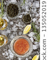 Red and black caviar are served with ice. A natural omega and a delicacy for the festive table. Lemon slices next to the caviar. Top view. 135052019