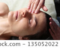 Facial massage. Facial care. A young woman in a beauty salon. The concept of beauty and health. 135052022