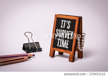 It's Survey Time Displayed On Small Wooden Sign With Pencils And Clip Nearby It's Survey Time Displayed On Small Wooden Sign With Pencils And Clip Nearby 135053122