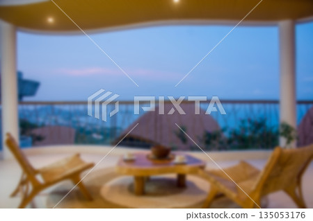 Blurred Luxury Resort Balcony with Ocean View and Evening Ambiance 135053176